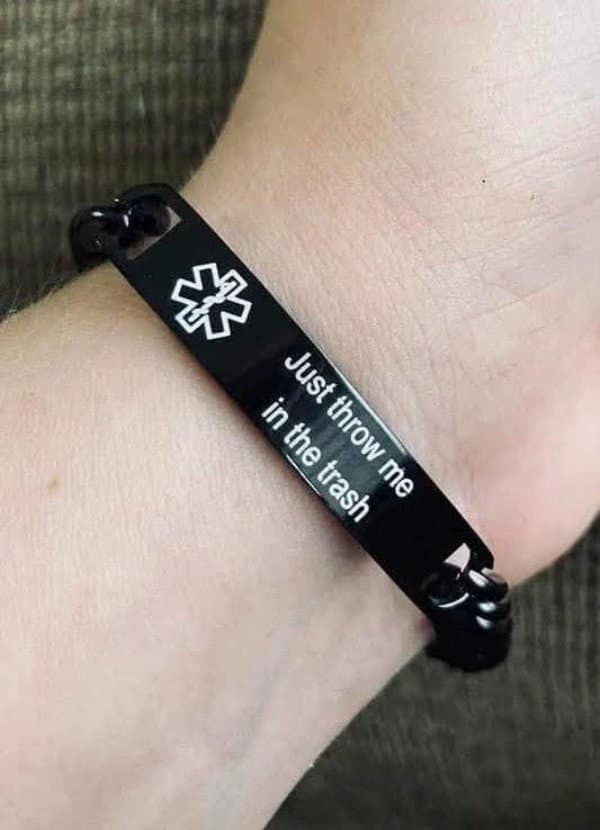 A classic meme photo of a medical alert bracelet engraved with the phrase Just throw me in the trash.
