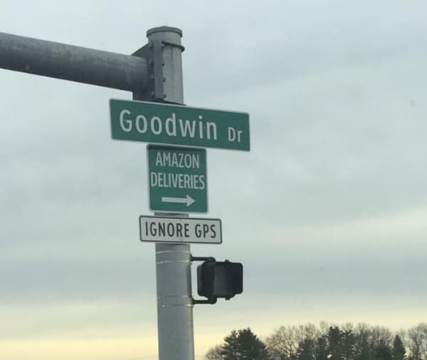 A street sign for Goodwin Dr with a smaller sign telling Amazon deliveries to Ignore GPS.