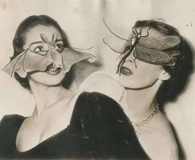 Two women posing in fashion shots wearing large realistic bat and dragonfly masks over their eyes.