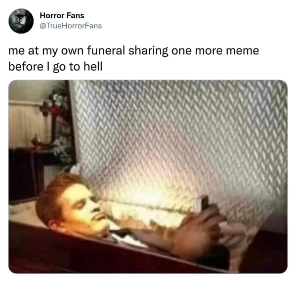 A dark humor meme of a man lying in a coffin checking his phone, captioned about sharing one last meme before going to hell.