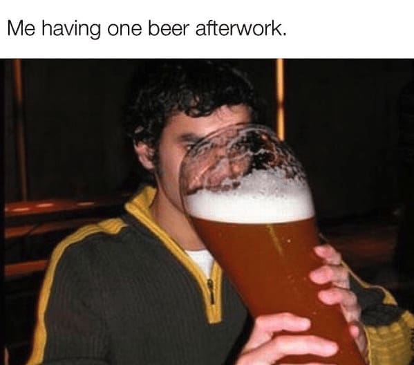 Man struggling to drink from a comically large giant beer glass after work.