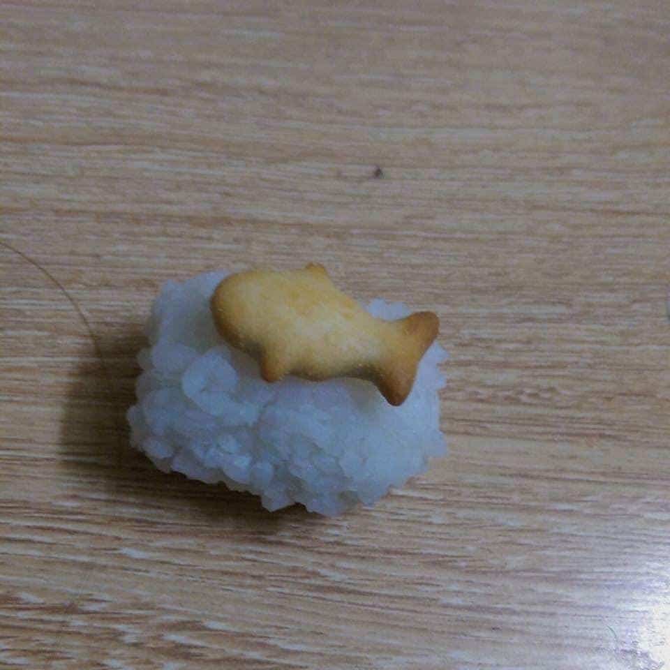 Goldfish cracker on rice block mimicking nigiri sushi food crimes.