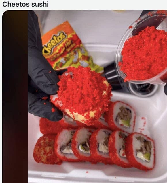 Sushi roll covered in red crushed Flamin Hot Cheetos dust.