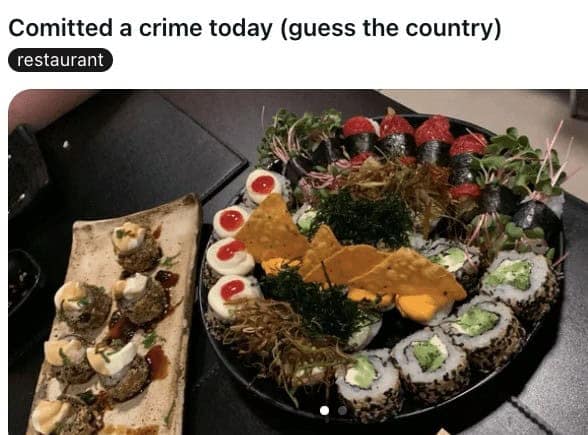 Sushi platter garnished with nacho cheese Doritos chips stuck in rolls.