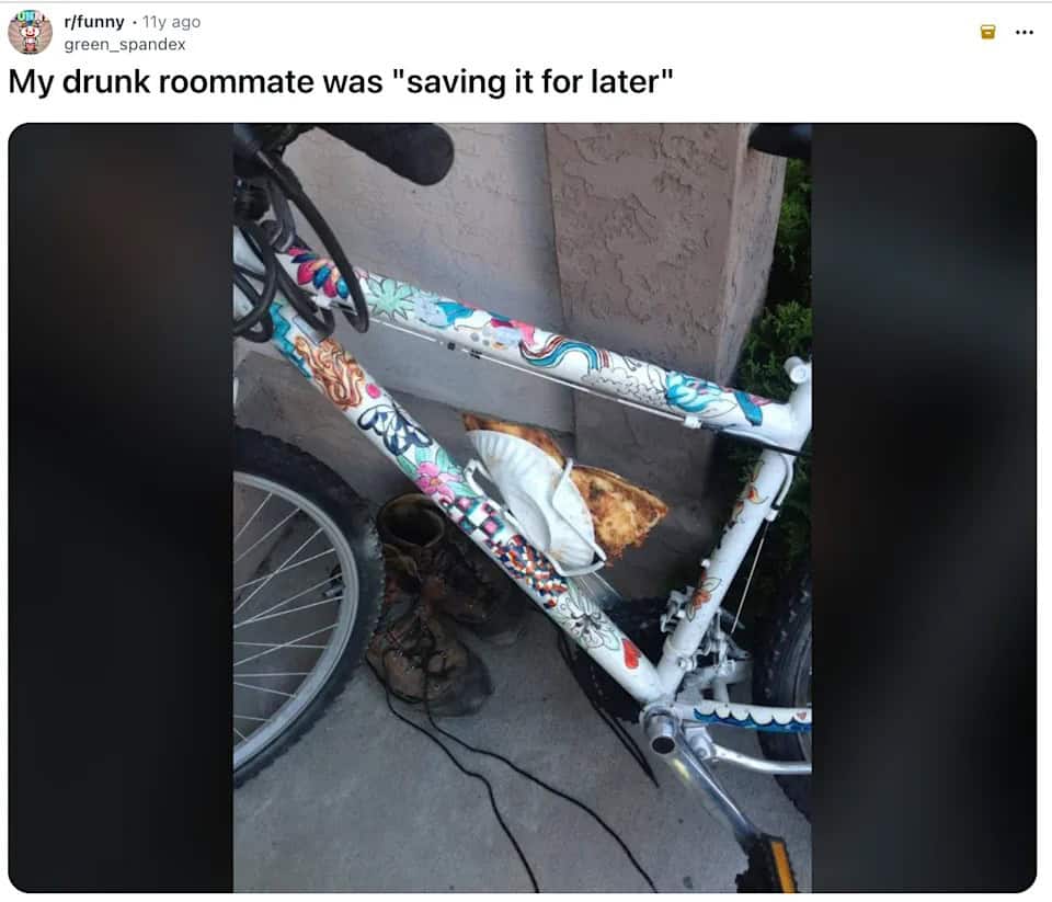 Slice of pizza stored in a bicycle water bottle holder on the frame.