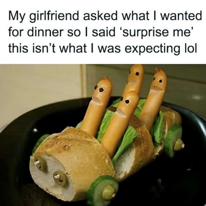 A funny food meme showing hot dogs made to look like people driving a bread car with cucumber wheels.