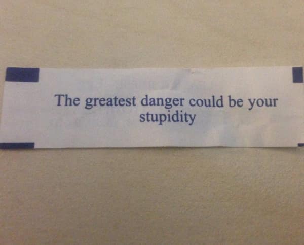 Fortune cookie paper saying the greatest danger could be your stupidity.