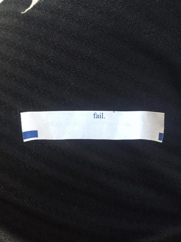 Small white fortune strip with the single word fail printed in blue.
