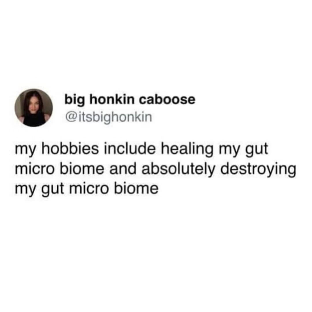 Man in a navy baseball cap aggressively shoveling food into his mouth from a bowl.