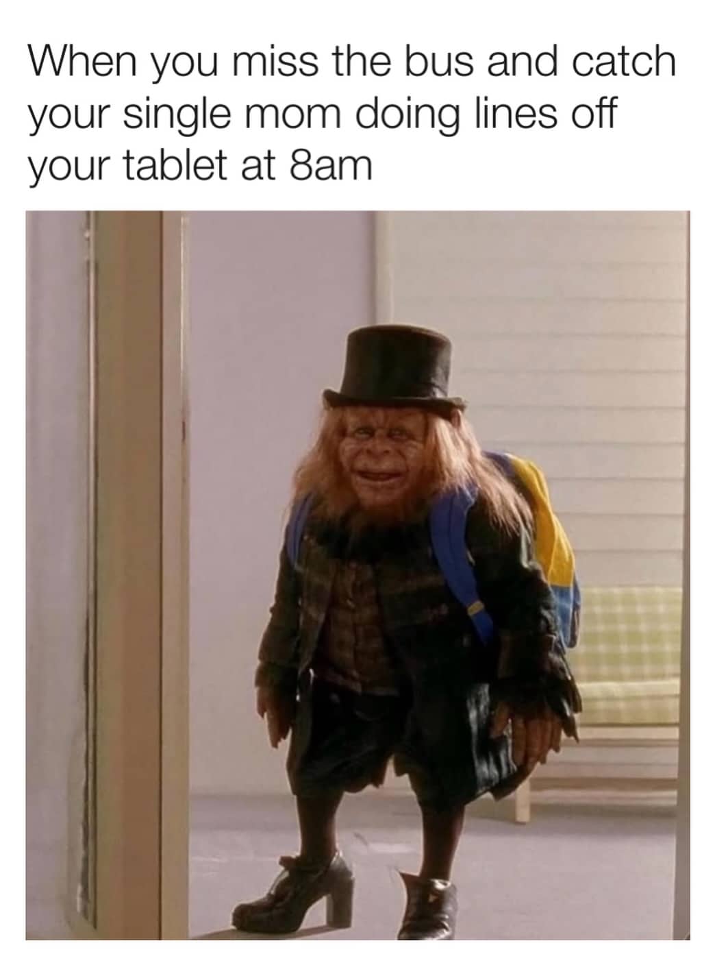 A small creature in a top hat and backpack standing in a doorway with a caption.