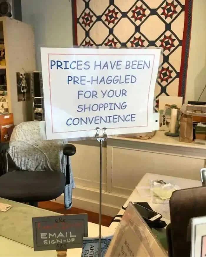 A sign in a retail store reading "Prices have been pre-haggled for your shopping convenience."