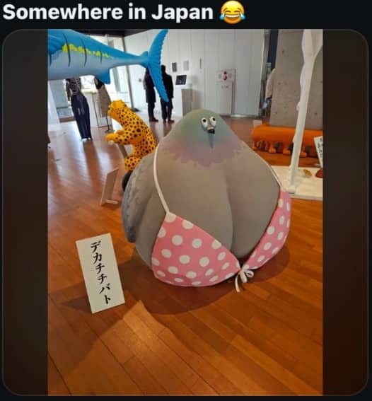 Large round pigeon statue wearing a pink polka dot bikini on display in Japan.