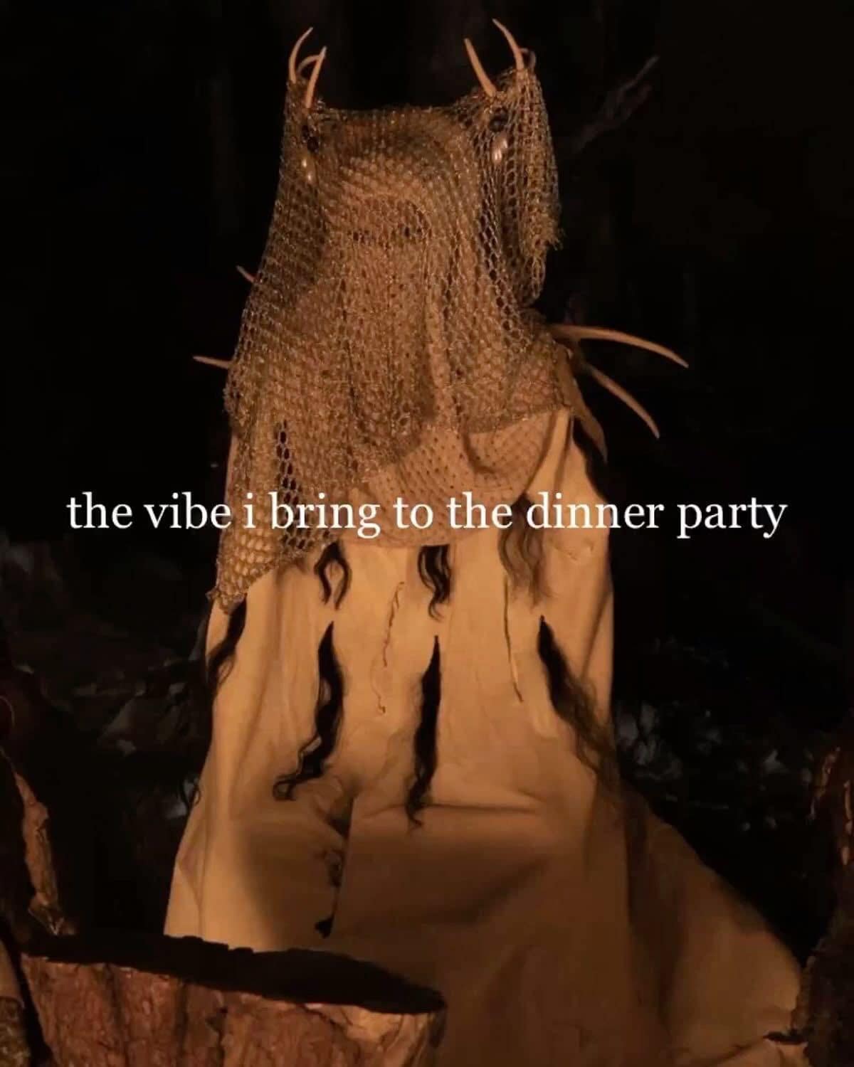 Creepy pagan costume figure sitting in dark vibes dinner party funny memes.