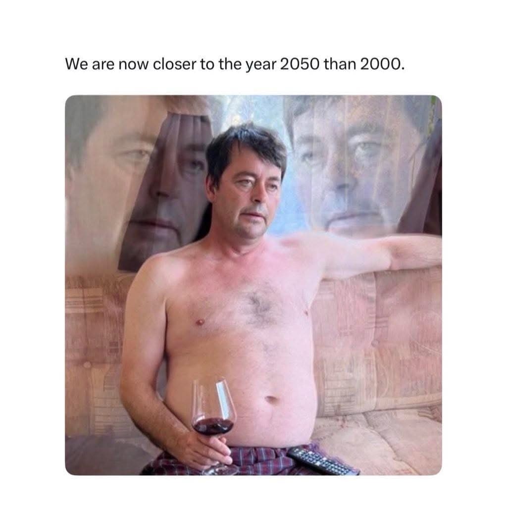 Man looking horrified on a couch realizing we are closer to 2050 than 2000.
