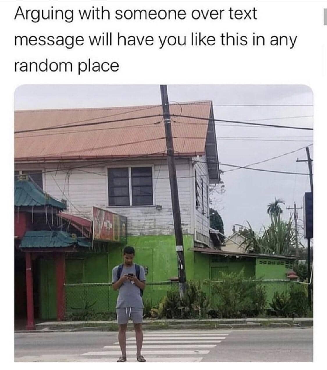 Man standing awkwardly on street corner while arguing over text message meme.