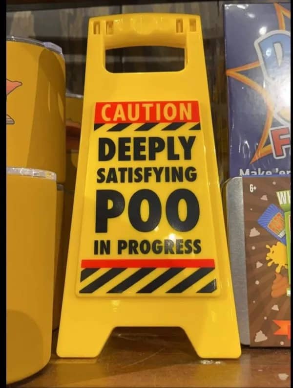 Yellow plastic caution floor sign warning of a deeply satisfying poo in progress.
