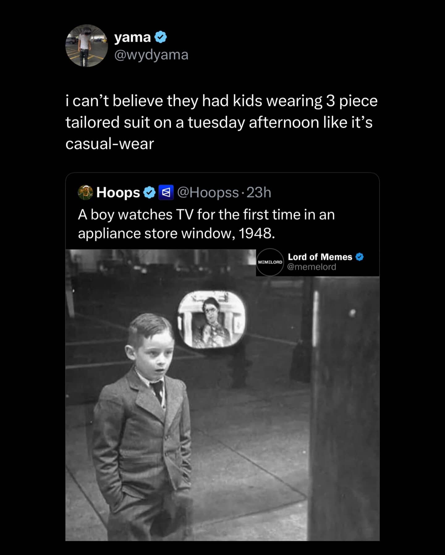 Vintage photo of boy in three piece suit watching TV window display in 1948.