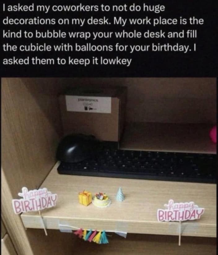 Photo of tiny birthday decorations on a desk for a lowkey celebration.