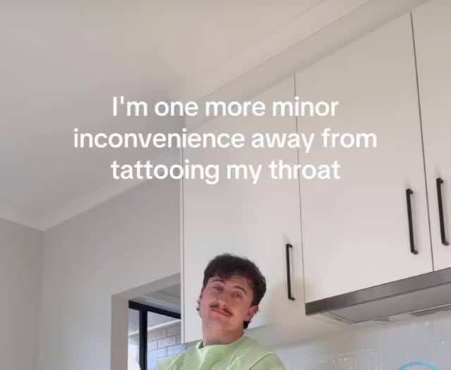 Man in kitchen contemplating throat tattoo due to minor inconveniences funny pics
