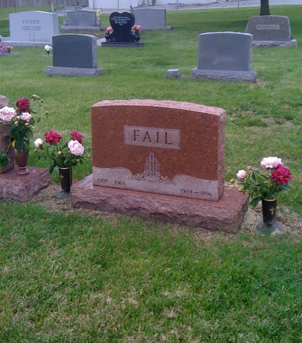 A red granite funny tombstone simply engraved with the word FAIL in large capital letters.
