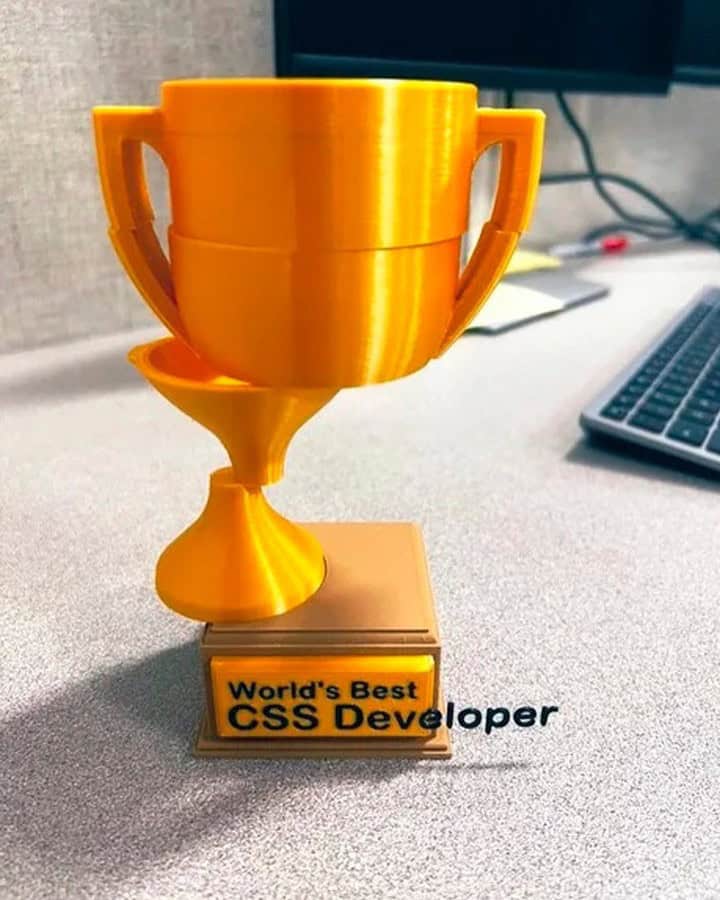 A graphic design meme photo of a trophy for "World's Best CSS Developer" where the cup is glitching out of the base.