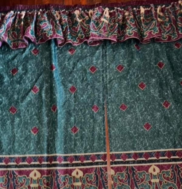 Window treatment valance with elaborate hunter green and maroon patterned fabric.