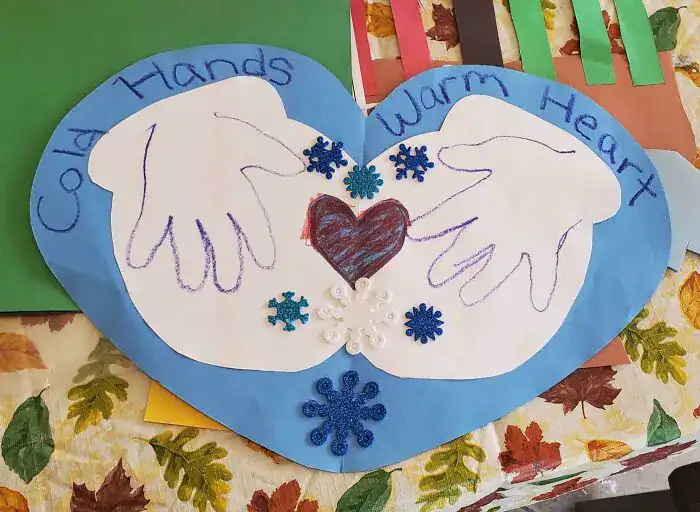 Paper craft with mittens saying Cold Hands Warm Heart kids drawings.This wholesome kids drawings craft project uses paper mittens to share a sweet sentiment about cold hands and warm hearts, perfect for winter refrigerator art.