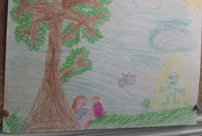 Crayon drawing of picnic interrupted by alien abduction beam kids drawings.