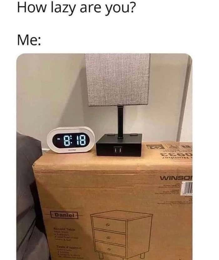 Lamp and clock on unassembled nightstand box meme showing extreme laziness.