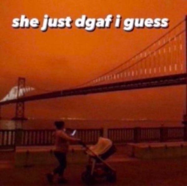 Woman casually strolling with a baby during an orange apocalyptic sky event.