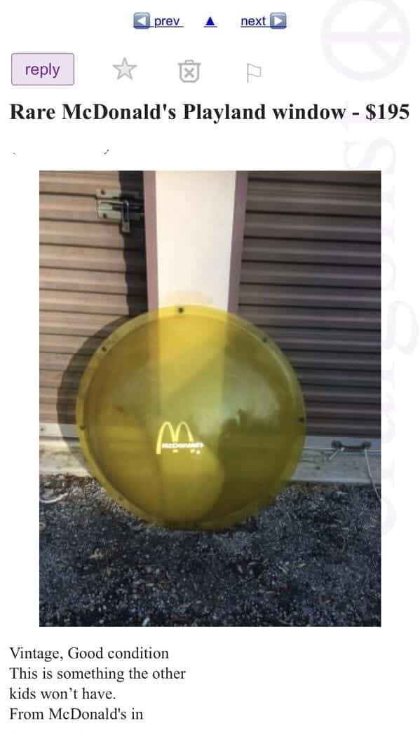 Yellow plastic bubble window from a McDonald's Playland leaning against storage unit.
