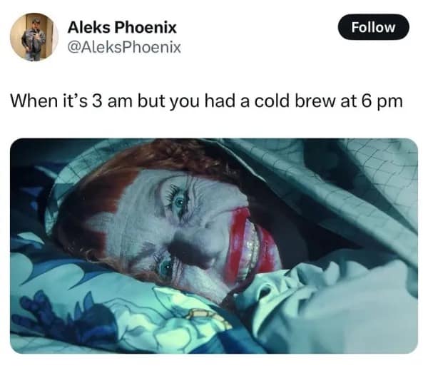 A funny meme of the Joker lying awake in bed wide eyed with a caption about drinking cold brew too late.