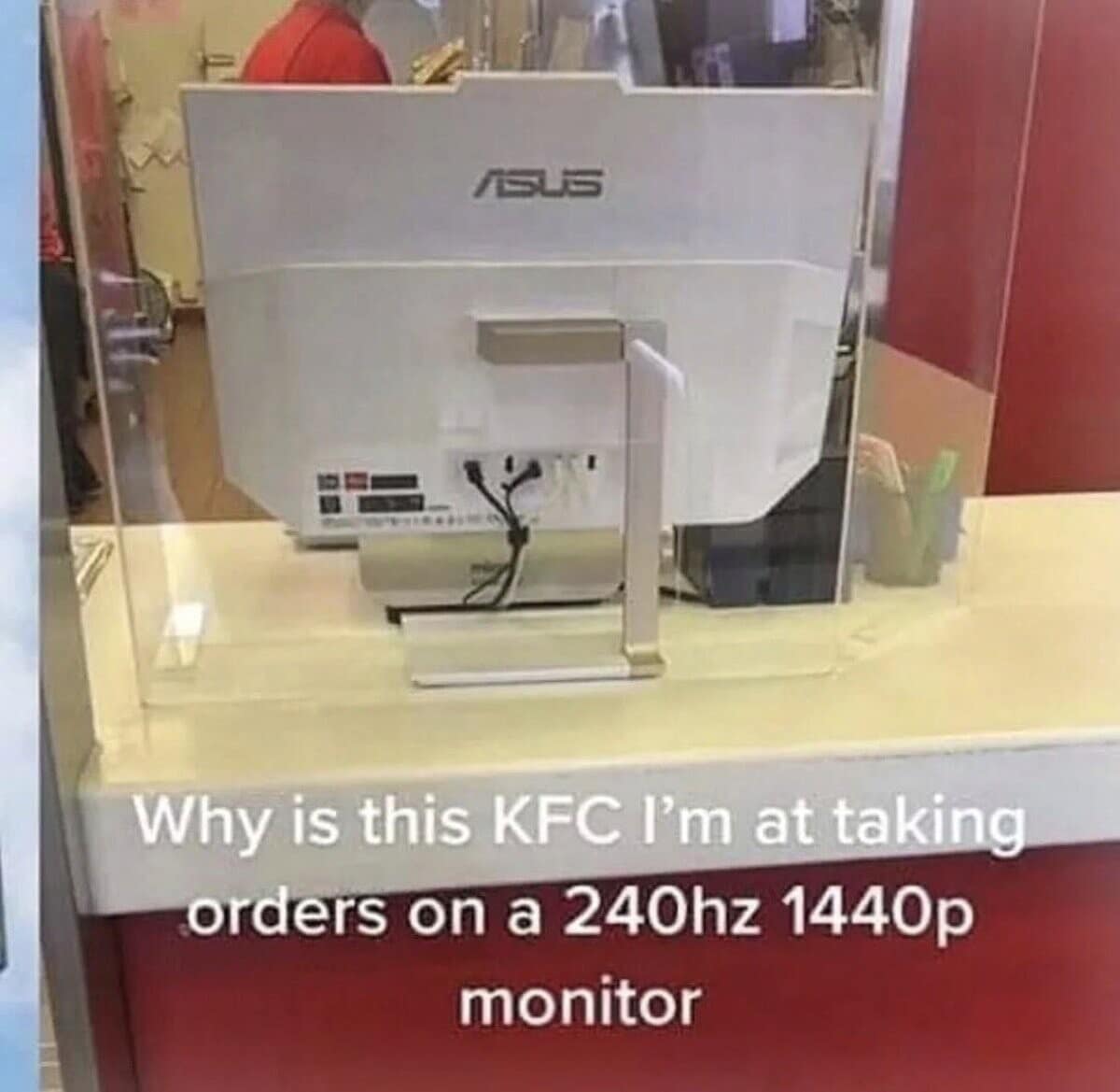 A funny meme showing a high-end ASUS gaming monitor being used as a cash register at a KFC.