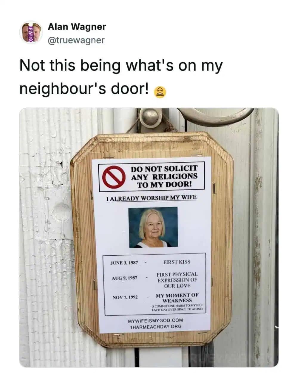 A funny meme photo of a door sign warning solicitors that the resident already worships his wife.