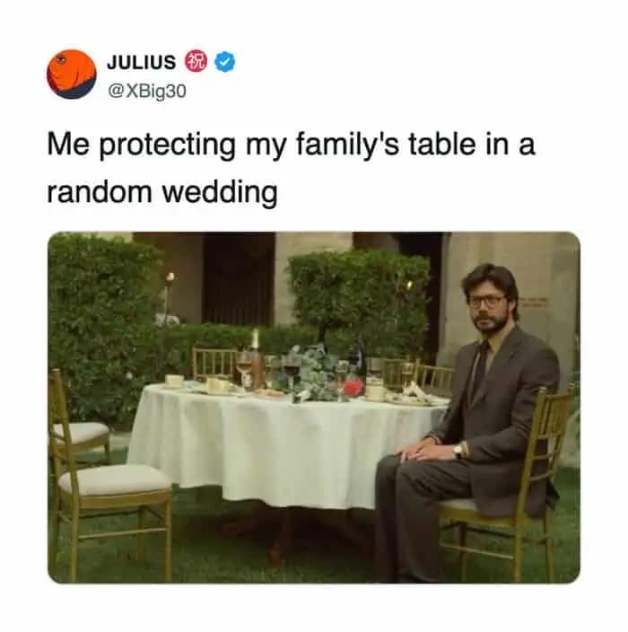 A funny meme showing The Professor from Money Heist sitting alone at a table protecting it at a wedding.