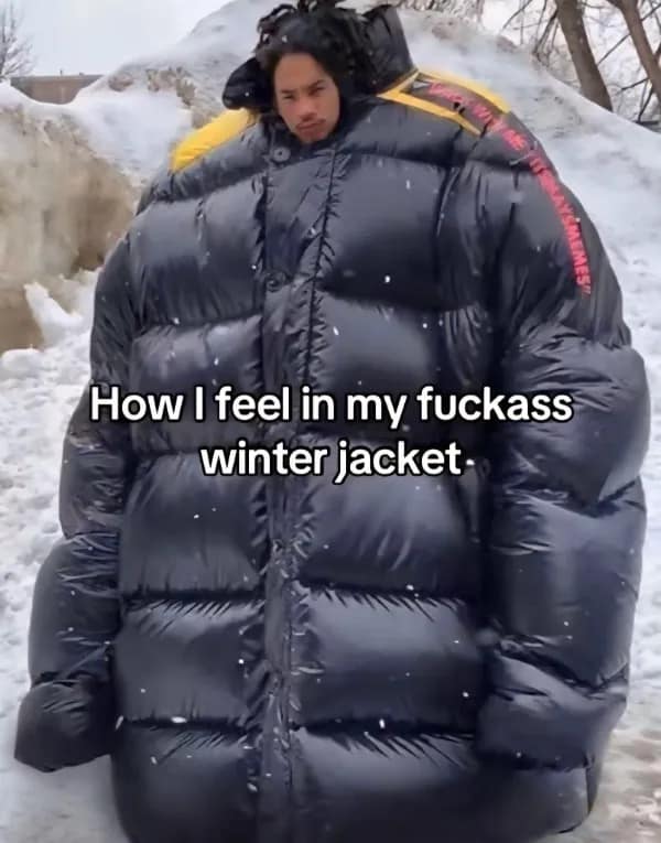 A funny meme of a person wearing an absurdly oversized, puffy black winter jacket that makes them look like a giant marshmallow.