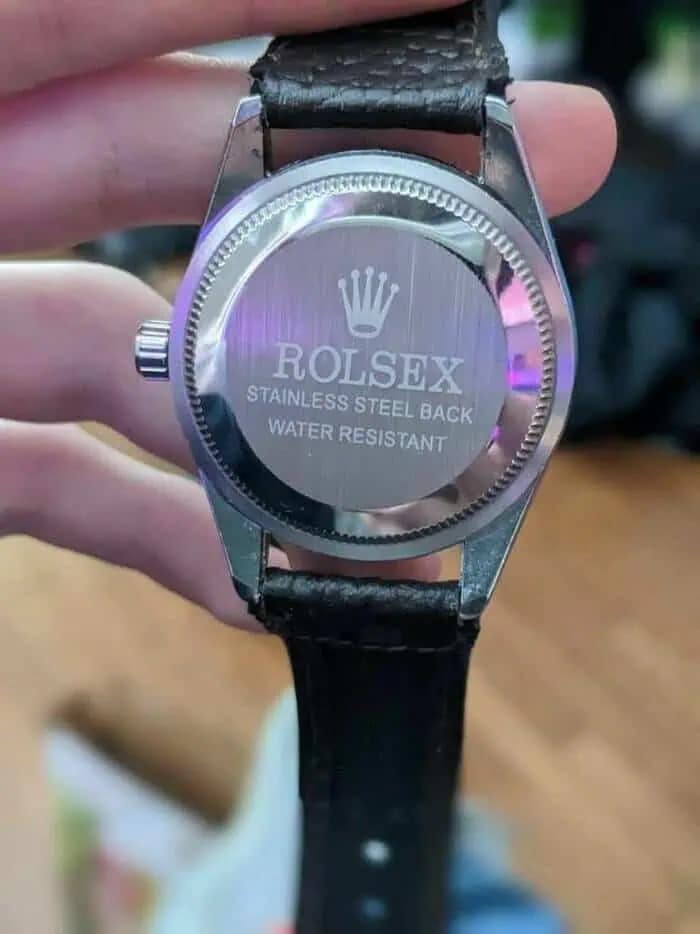 A funny meme photo of a counterfeit watch with the misspelled brand name Rolsex on the back.