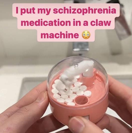 A funny meme showing a mini claw machine filled with white pills labeled as schizophrenia medication.