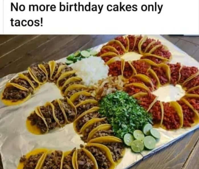 A large platter of tacos arranged in the shape of the number thirty.