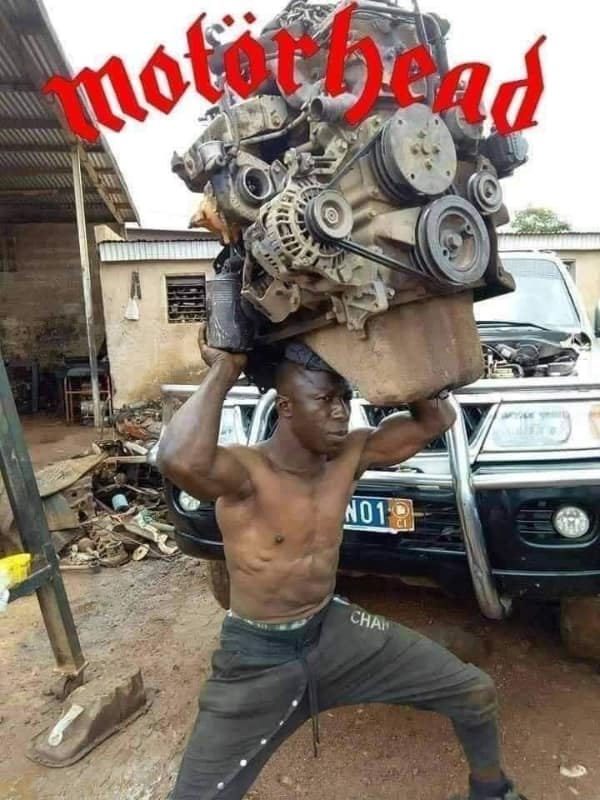 A music meme showing a man carrying a car engine on his head with the band logo Motörhead.