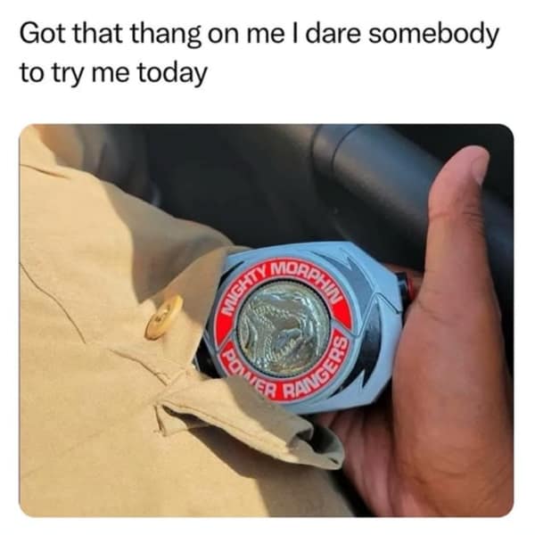 A person revealing a Power Rangers morpher tucked into their shirt like a hidden badge