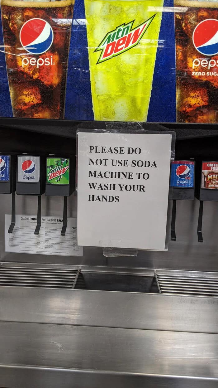 Soda fountain warning sign forbidding customers from washing hands in dispenser.