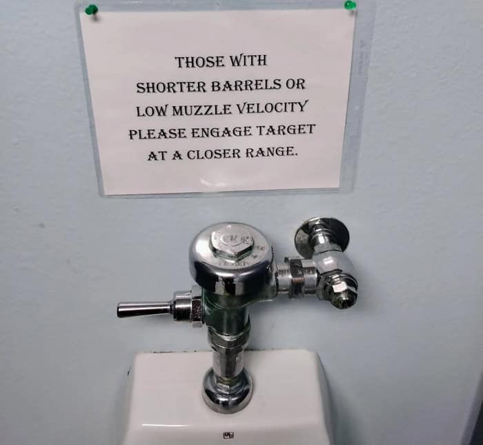 Bathroom sign using military terms for urinal aim and distance.