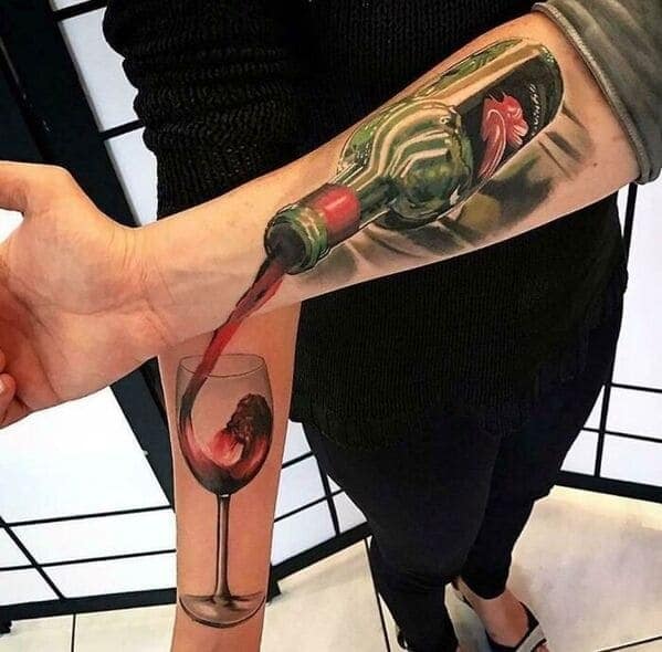 Wine bottle pouring into glass optical illusion tattoo on forearm questionable tattoos.