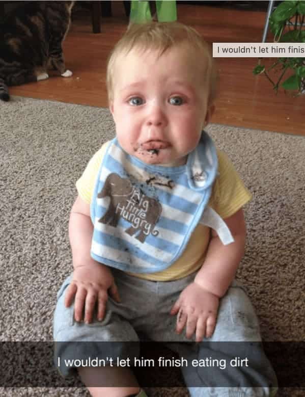 Baby with dirt all over mouth crying because he was stopped from eating more dirt.