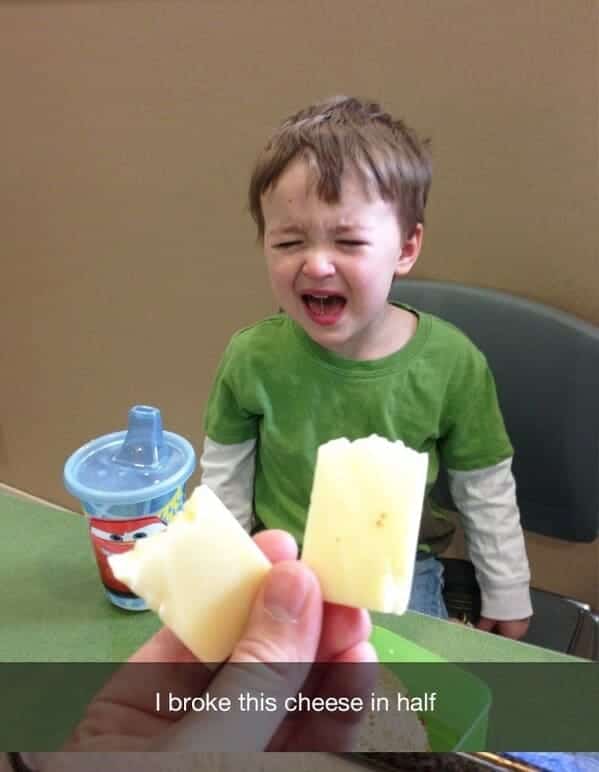 Toddler crying hysterically because a slice of cheese was broken in half by a parent.