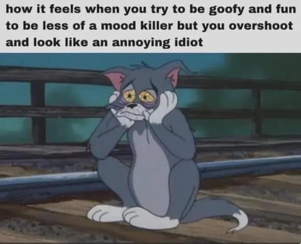 A relatable meme showing Tom the cat looking beaten up and exhausted sitting on train tracks.