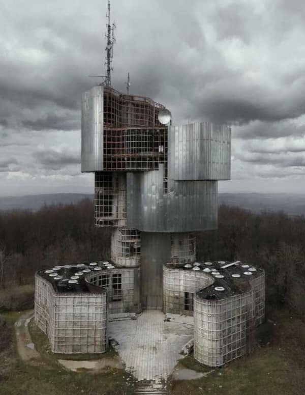 A strange concrete futuristic structure on a hill, an obvious super villain lair.