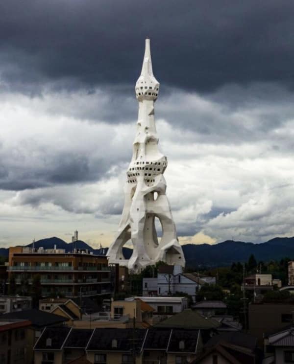 A white organic looking tower resembling a bone structure, a sinister building.