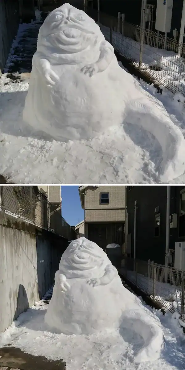 Realistic Jabba the Hutt snow sculpture in a backyard.